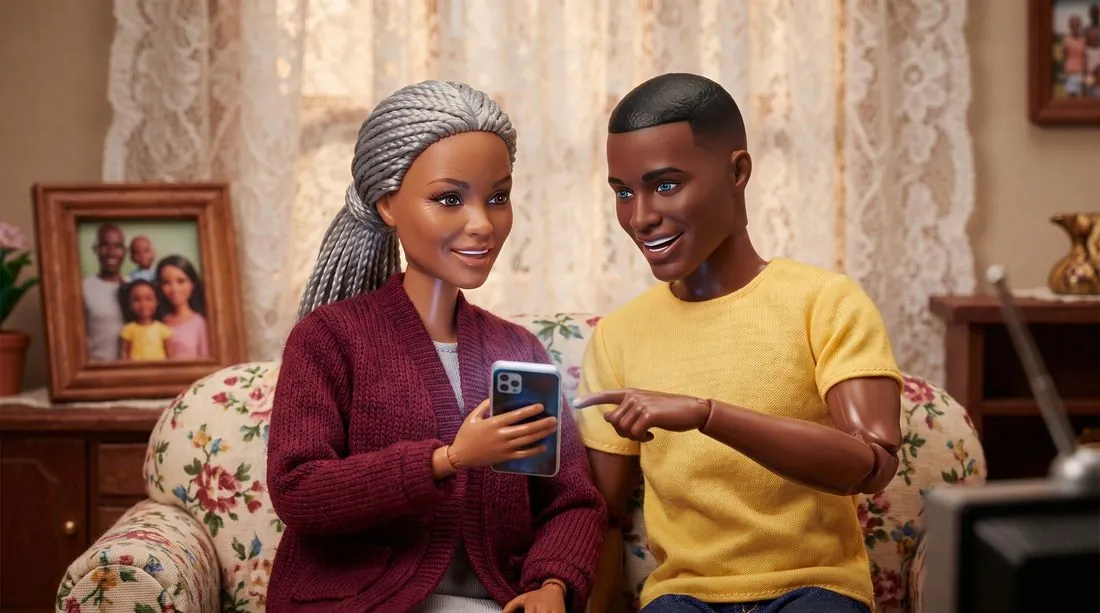 A gran and her grandson looking at a phone together